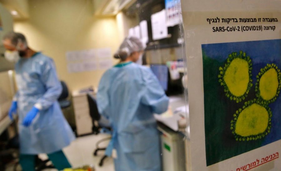 Lab technicians test samples of suspected COVID-19 patients at the Hadassah Ein Kerem Hospital in Jerusalem