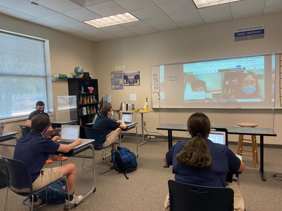 Ms. Rosenthal’s upper school history class is working hard to include virtual students by projecting them onto the white board.