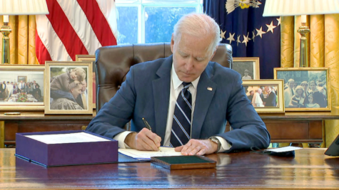 President Joe Biden signs the 1.9 trillion dollar COVID relief bill into law (CNN)
