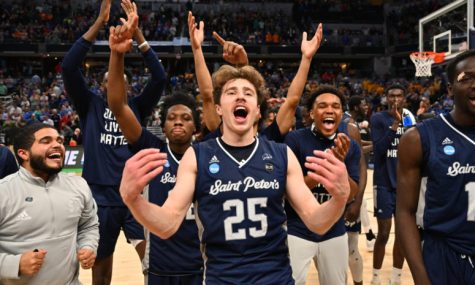 The Saint Peters Peacocks celebrating their March Madness win.