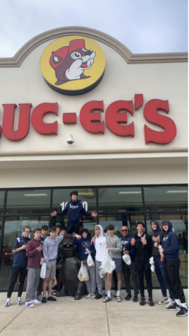 Coach Heather Williams shares a bonding experience with the boys team at Buccees on the way to a playoff game.