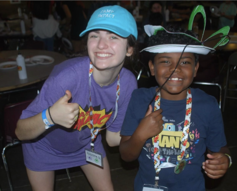 Sophomore, Juliette Hess at Camp Impact with one of her campers!